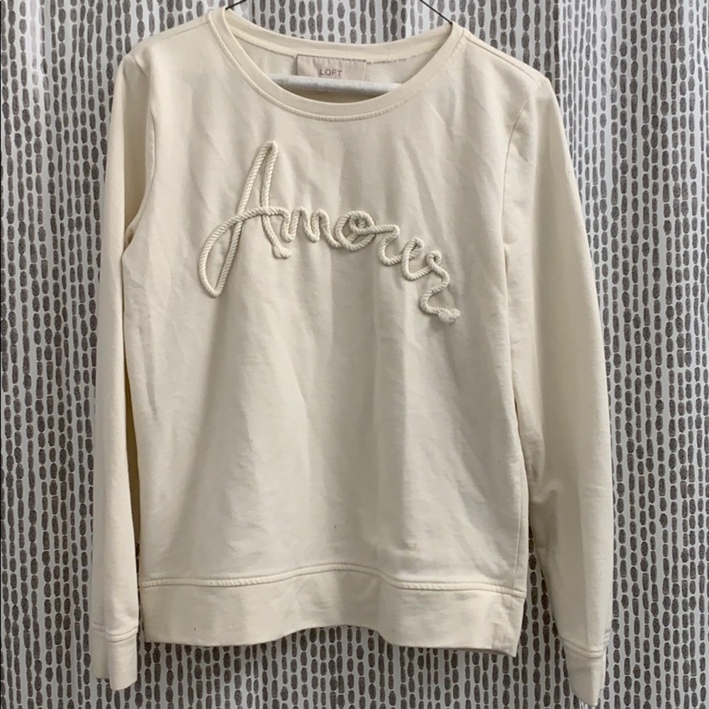 Cream colored crewneck sweatshirt
